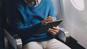 Side view portrait of handsome bearded businessman working while enjoying flight in first class, copy space video