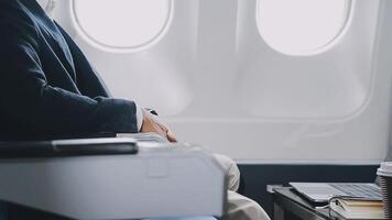 Side view portrait of handsome bearded businessman working while enjoying flight in first class, copy space video