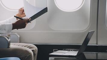 Side view portrait of handsome bearded businessman working while enjoying flight in first class, copy space video