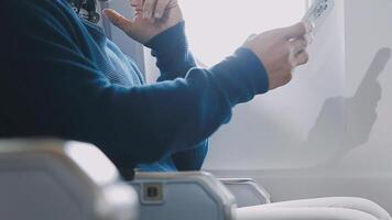 Side view portrait of handsome bearded businessman working while enjoying flight in first class, copy space video