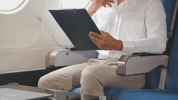 Side view portrait of handsome bearded businessman working while enjoying flight in first class, copy space video