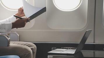 Side view portrait of handsome bearded businessman working while enjoying flight in first class, copy space video