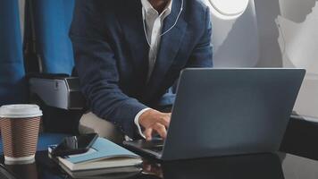 Side view portrait of handsome bearded businessman working while enjoying flight in first class, copy space video