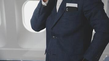 Side view portrait of handsome bearded businessman working while enjoying flight in first class, copy space video