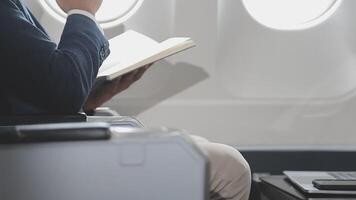 Side view portrait of handsome bearded businessman working while enjoying flight in first class, copy space video