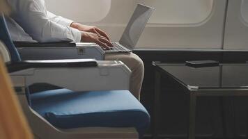 Side view portrait of handsome bearded businessman working while enjoying flight in first class, copy space video