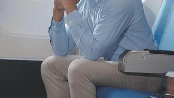 Side view portrait of handsome bearded businessman working while enjoying flight in first class, copy space video