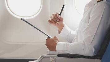 Side view portrait of handsome bearded businessman working while enjoying flight in first class, copy space video