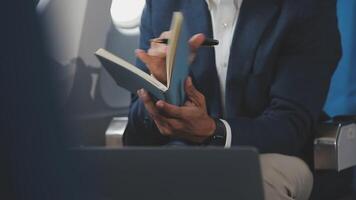 Side view portrait of handsome bearded businessman working while enjoying flight in first class, copy space video