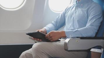 Side view portrait of handsome bearded businessman working while enjoying flight in first class, copy space video