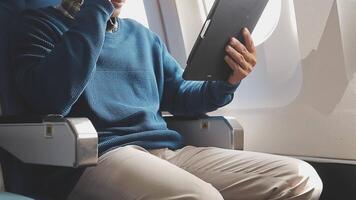 Side view portrait of handsome bearded businessman working while enjoying flight in first class, copy space video