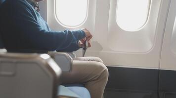 Side view portrait of handsome bearded businessman working while enjoying flight in first class, copy space video