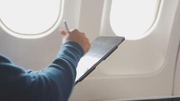 Side view portrait of handsome bearded businessman working while enjoying flight in first class, copy space video