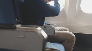 Side view portrait of handsome bearded businessman working while enjoying flight in first class, copy space video