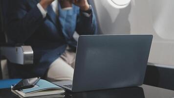 Side view portrait of handsome bearded businessman working while enjoying flight in first class, copy space video