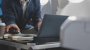 Side view portrait of handsome bearded businessman working while enjoying flight in first class, copy space video