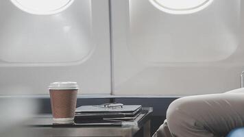 Side view portrait of handsome bearded businessman working while enjoying flight in first class, copy space video