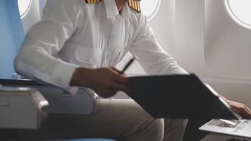 Side view portrait of handsome bearded businessman working while enjoying flight in first class, copy space video