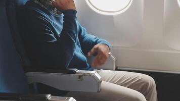 Side view portrait of handsome bearded businessman working while enjoying flight in first class, copy space video