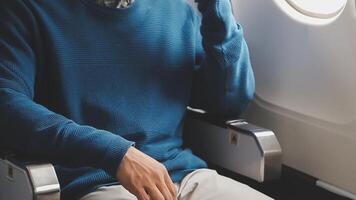 Side view portrait of handsome bearded businessman working while enjoying flight in first class, copy space video