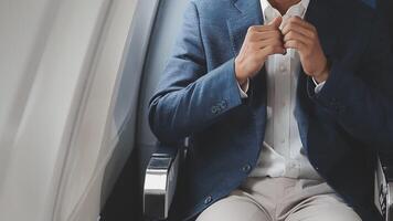 Side view portrait of handsome bearded businessman working while enjoying flight in first class, copy space video