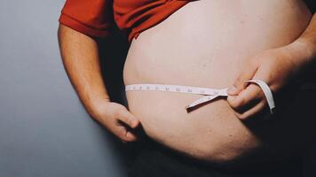 Man pointing own unhealthy big belly with visceral or subcutaneous fats. Pose health risk. video