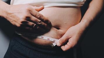 Man pointing own unhealthy big belly with visceral or subcutaneous fats. Pose health risk. video