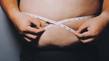 Man pointing own unhealthy big belly with visceral or subcutaneous fats. Pose health risk. video