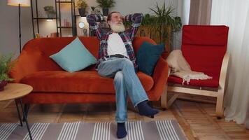 Happy calm senior man smiling dreaming resting, relaxing, good news, feel satisfied at home couch video