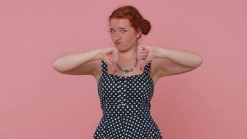 Upset woman in dress showing thumbs down sign gesture, disapproval, dissatisfied dislike video