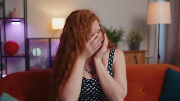 Upset disappointed redhead adult girl wipes tears and cries from despair, unrequited love, problems video