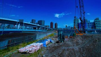 A timelapse of moving cranes at the under construction in Tokyo wide shot panning video