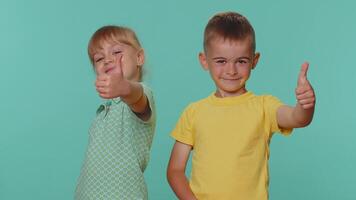 Little toddler children boy and girl siblings raises thumbs up, like, agrees or gives positive reply video