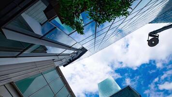 een timelapse van de wolk reflecterend de spiegel van de gebouw in tokyo breed schot pannen video