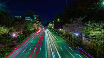 A night timelapse of the cherry street at Yasukuni avenue in Tokyo wide shot panning video