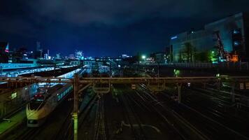 A timelapse of the train at Ueno station at night long exposure wide shot panning video