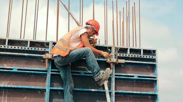 An engineer installs metal structures during the construction of a house. Installation of metal structures for reinforced concrete. video