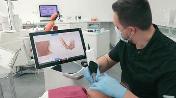 Dentist scans the patient's teeth using the CEREC scanner. Modern dentistry. The dentist uses a 3D dental intraoral scanner to scan the patient's teeth video