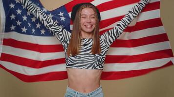 Lovely young woman waving and wrapping in American USA flag, celebrating, human rights and freedoms video