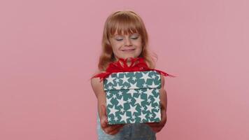 Lovely smiling preteen child girl kid presenting birthday gift box offer wrapped present celebrating video