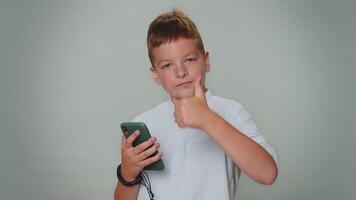 Toddler boy using mobile phone typing post on web sms message browsing addiction of social networks video