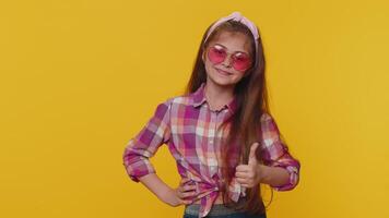 Child girl kid wearing pink sunglasses, charming smile, showing thumbs up like, positive feedback video