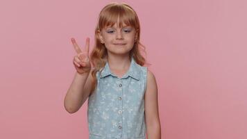 Happy preteen child girl kid showing victory sign, hoping for success and win, doing peace gesture video