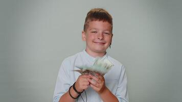 Toddler boy holding cash money dollar celebrate dance, success business career, lottery game winner video