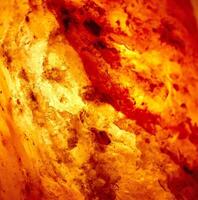 Detail of a lit salt lamp showing salt crystals illuminated by the light behind it. Square Image. photo