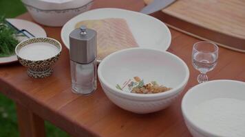 cooking outdoors. ingredients for cooking fish are on the table in plates video