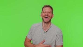 Bearded young man laughing out loud after hearing ridiculous anecdote, funny joke, feeling carefree video