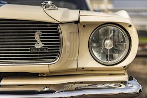 Vicenza Italy 19 March 2024 The iconic Cobra emblem adorns the grille of a Ford Mustang symbolizing power and performance photo