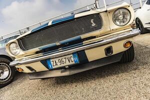 Vicenza Italy 19 March 2024 The iconic Cobra emblem adorns the grille of a Ford Mustang symbolizing power and performance photo