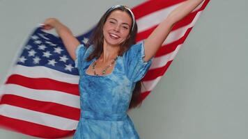 Lovely young woman waving and wrapping in American USA flag, celebrating, human rights and freedoms video